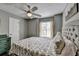 Cozy bedroom features a ceiling fan, soft lighting, and a comfortable bed at 7040 Shady Oak Ln, Cumming, GA 30040