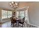 Bright dining area featuring a chandelier and bay window, offering a pleasant space for meals at 7040 Shady Oak Ln, Cumming, GA 30040