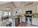 Bright kitchen features stainless appliances, granite countertops, and adjacent dining area at 7040 Shady Oak Ln, Cumming, GA 30040