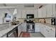 Stylish kitchen with stainless steel appliances and granite countertops offering plenty of cooking space at 7040 Shady Oak Ln, Cumming, GA 30040