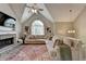 Cozy living room featuring a fireplace, vaulted ceilings, and ample natural light, perfect for relaxation at 7040 Shady Oak Ln, Cumming, GA 30040