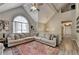 Comfortable living space with vaulted ceilings and a large window, creating a bright and airy atmosphere at 7040 Shady Oak Ln, Cumming, GA 30040