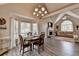 Open-concept dining and living space with a fireplace, creating a warm and inviting atmosphere at 7040 Shady Oak Ln, Cumming, GA 30040