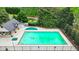 Aerial view of a large community swimming pool surrounded by lush landscaping, offering a refreshing escape at 7040 Shady Oak Ln, Cumming, GA 30040
