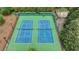 View of two well-maintained tennis courts surrounded by fencing and lighting, perfect for evening games at 7040 Shady Oak Ln, Cumming, GA 30040
