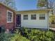 View of the back of a brick home with white siding, and landscaping at 1368 Scott Blvd, Decatur, GA 30030
