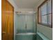 This bathroom features turquoise tile, a matching toilet and tub, and a glass shower door at 1368 Scott Blvd, Decatur, GA 30030