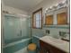 Bathroom features turquoise tile, a matching toilet and tub, and a glass shower door at 1368 Scott Blvd, Decatur, GA 30030