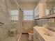 Bathroom with marble walk-in shower, sink, toilet, medicine cabinet, and window at 1368 Scott Blvd, Decatur, GA 30030