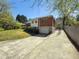 A view of the home's exterior showing the driveway, garage, and brick and siding exterior at 1368 Scott Blvd, Decatur, GA 30030