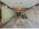 View of the garage interior with stone walls, ceiling, and concrete floors at 1368 Scott Blvd, Decatur, GA 30030