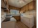 Kitchen with wood cabinets, laundry, and white appliances at 1368 Scott Blvd, Decatur, GA 30030