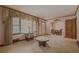 Inviting living room featuring classic window treatments, neutral carpet, and seamless flow into the dining area at 1368 Scott Blvd, Decatur, GA 30030