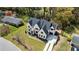 Beautiful aerial view of a white brick home with a dark roof, set on a well-maintained lawn with mature trees at 312 Meadow Dr, Alpharetta, GA 30009