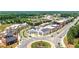 Wide aerial view showcasing attractive, walkable community with tree-lined streets and roundabout at 312 Meadow Dr, Alpharetta, GA 30009