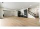Open basement featuring light hardwood floors, a wet bar, and access to the upper levels at 312 Meadow Dr, Alpharetta, GA 30009