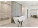 Luxurious bathroom with stone floors, a soaking tub, a walk-in shower, and access to the main bedroom at 312 Meadow Dr, Alpharetta, GA 30009