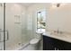 Bright bathroom featuring a glass shower, patterned tile flooring, and a black vanity at 312 Meadow Dr, Alpharetta, GA 30009