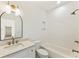 Modern bathroom featuring a white vanity, gold fixtures, a tub, and tiled walls at 312 Meadow Dr, Alpharetta, GA 30009