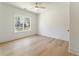 Bedroom featuring light hardwood floors, white walls, a ceiling fan, and outdoor views at 312 Meadow Dr, Alpharetta, GA 30009