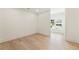 A bright room with hardwood floors, a window, and access to another room at 312 Meadow Dr, Alpharetta, GA 30009