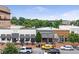 View of commercial district featuring shops and restaurants with outdoor seating and street parking at 312 Meadow Dr, Alpharetta, GA 30009