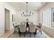 Modern dining room with neutral tones, a stylish chandelier, and ample natural light from the large windows at 312 Meadow Dr, Alpharetta, GA 30009