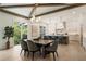 Elegant dining area open to the kitchen, with hardwood floors and a large window showcasing the natural surroundings at 312 Meadow Dr, Alpharetta, GA 30009