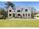 New construction featuring a bright white brick home with black window trim and a manicured lawn at 312 Meadow Dr, Alpharetta, GA 30009