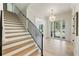 Foyer with hardwood floors, staircase, and French doors leading to outside at 312 Meadow Dr, Alpharetta, GA 30009
