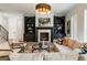 Warm and inviting living room with a fireplace, built-in bookshelves, and comfortable seating at 312 Meadow Dr, Alpharetta, GA 30009