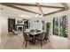 Open-concept living space featuring a fireplace, dining area, and large windows with wooded views at 312 Meadow Dr, Alpharetta, GA 30009
