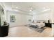 Spacious main bedroom featuring hardwood floors, a tray ceiling with a ceiling fan, and decorative wall trim at 312 Meadow Dr, Alpharetta, GA 30009