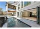 Stunning outdoor space featuring a pool, outdoor kitchen, and access to the home's modern interior through folding glass doors at 312 Meadow Dr, Alpharetta, GA 30009