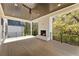 Covered porch with a cozy fireplace and ceiling fan overlooking the landscaped backyard at 312 Meadow Dr, Alpharetta, GA 30009