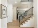 Elegant staircase with hardwood steps and a dark railing, leading to the upper level of the home at 312 Meadow Dr, Alpharetta, GA 30009