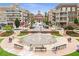 Vibrant town center with shops and restaurants surrounding a water fountain, creating a lively community space at 312 Meadow Dr, Alpharetta, GA 30009