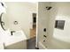 Modern bathroom featuring a tub, walk-in shower, sleek fixtures, and a stylish black and white design at 4336 Parkview Dr, Lithia Springs, GA 30122