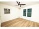 Bedroom featuring updated windows, wood grain floors, freshly painted walls and ceiling fan at 4336 Parkview Dr, Lithia Springs, GA 30122