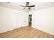 Bedroom featuring wood grain flooring, updated paint, closet, ceiling fan, and attached bathroom at 4336 Parkview Dr, Lithia Springs, GA 30122