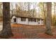 Charming single-story home with a white brick exterior and mature trees in a peaceful setting at 4336 Parkview Dr, Lithia Springs, GA 30122