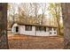 Charming single-story home with a white brick exterior and mature trees in a peaceful setting at 4336 Parkview Dr, Lithia Springs, GA 30122
