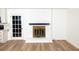 Bright living room features beautiful white brick fireplace, stylish dark mantel, and wood grain flooring at 4336 Parkview Dr, Lithia Springs, GA 30122