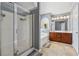 Bathroom featuring a glass shower, soaking tub, double sink vanity and neutral tile floors at 6015 Crestwick Way, Cumming, GA 30040