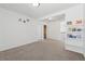 Neutral bonus room is carpeted and includes shelving for book storage and easy access to the laundry room at 6015 Crestwick Way, Cumming, GA 30040