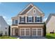Charming two-story home boasts brick accents, a two-car garage, and a well-manicured lawn in a suburban setting at 6015 Crestwick Way, Cumming, GA 30040