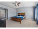 A primary bedroom with a vaulted ceiling, ceiling fan, dresser and a wood bed at 6015 Crestwick Way, Cumming, GA 30040