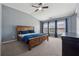 A primary bedroom with a vaulted ceiling, ceiling fan and a wood bed at 6015 Crestwick Way, Cumming, GA 30040