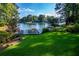 Lush green backyard with access to a lake featuring a private boat dock and plenty of space for recreation at 1187 Plantation Dr, Villa Rica, GA 30180