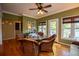 Cozy dining area with wood floors, large windows offering natural light, and a view of the lake at 1187 Plantation Dr, Villa Rica, GA 30180